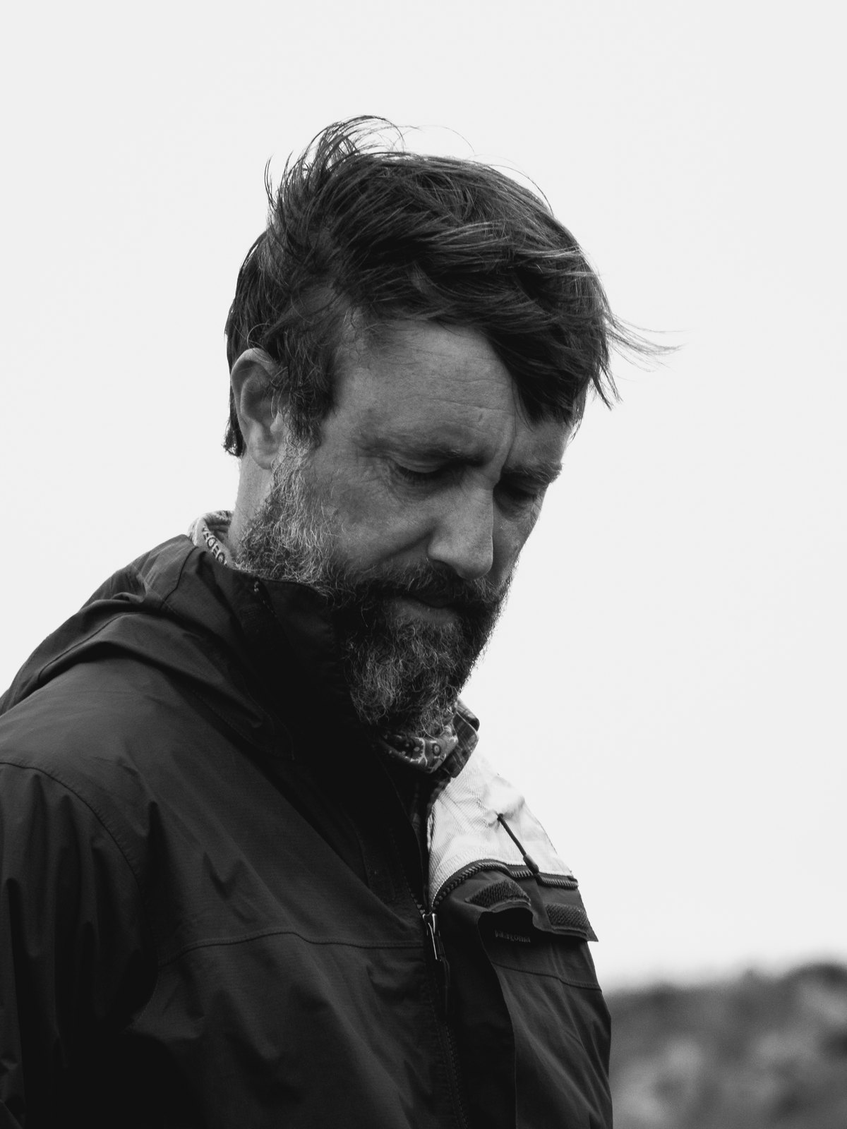 Chad Prevost, wind-blown, head bowed — black and white