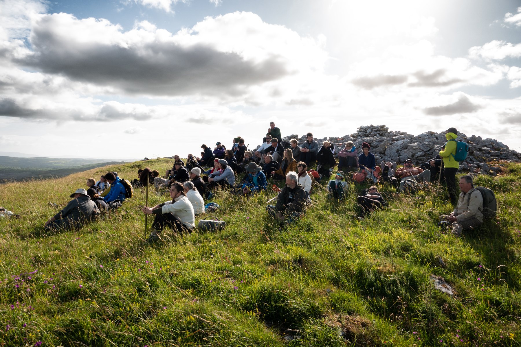 A retreat session gathered on a sunlit hillside